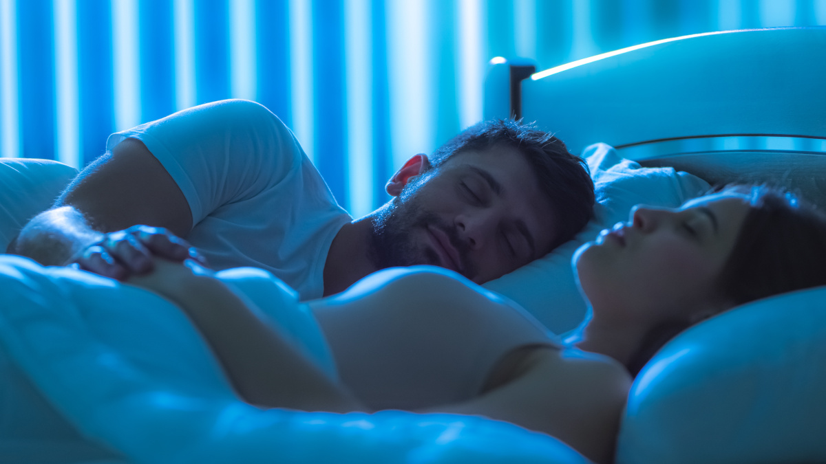 Couple asleep in bed