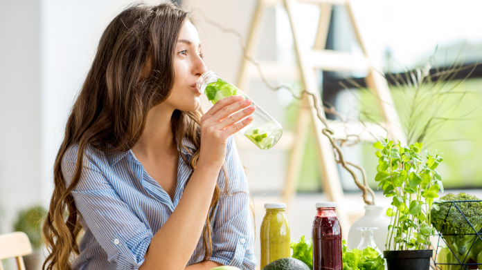 Young woman drinking a detox juice